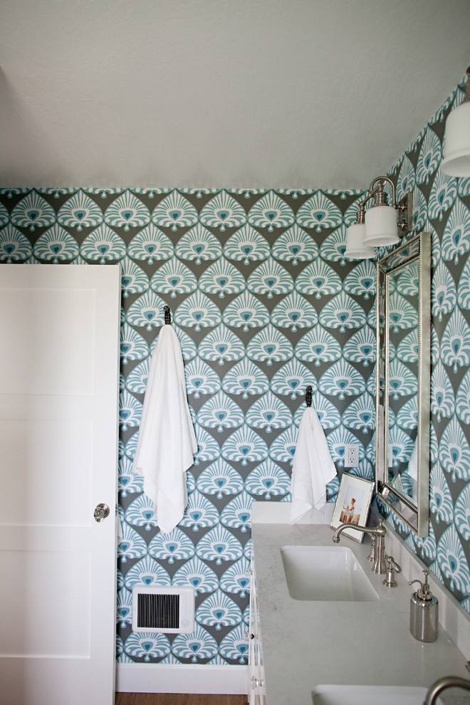 Inspiration for a large beach style kids bathroom in San Francisco with recessed-panel cabinets, white cabinets, a drop-in tub, an alcove shower, a two-piece toilet, white tile, mosaic tile, multi-coloured walls, dark hardwood floors, a drop-in sink and engineered quartz benchtops.