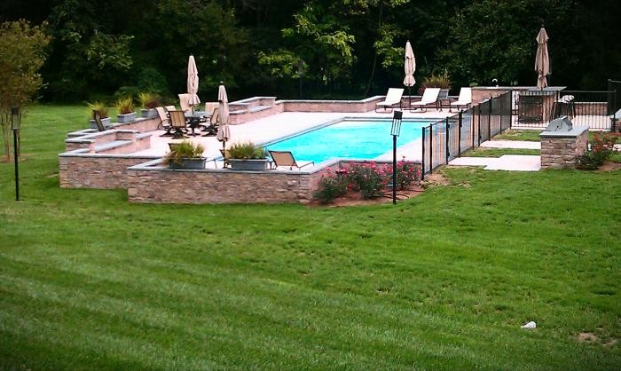 Example of a large transitional backyard stone and custom-shaped natural pool fountain design in Baltimore