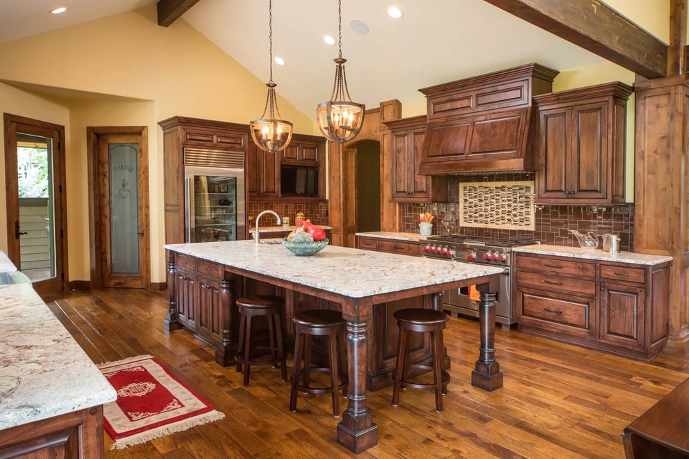 Inspiration for a large rustic u-shaped medium tone wood floor kitchen remodel with medium tone wood cabinets, brown backsplash, glass tile backsplash, a farmhouse sink, beaded inset cabinets, granite countertops, stainless steel appliances and an island