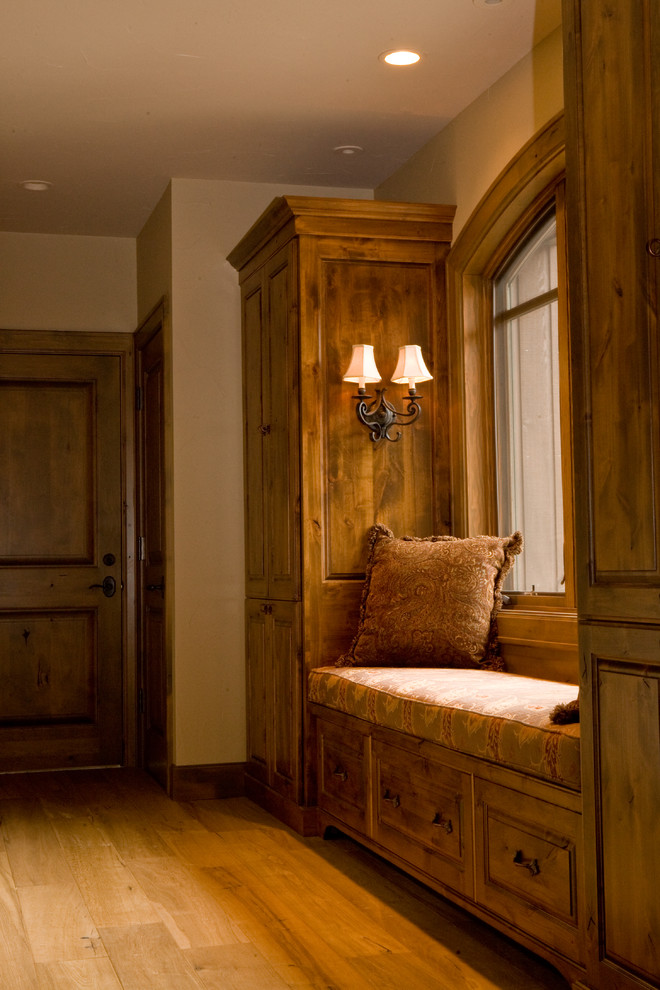 This is an example of a mid-sized arts and crafts hallway in Other with brown walls, light hardwood floors and brown floor.