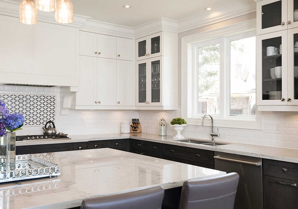 Open concept kitchen - large transitional l-shaped dark wood floor open concept kitchen idea in Toronto with an undermount sink, recessed-panel cabinets, white cabinets, quartzite countertops, white backsplash, subway tile backsplash, stainless steel appliances and an island