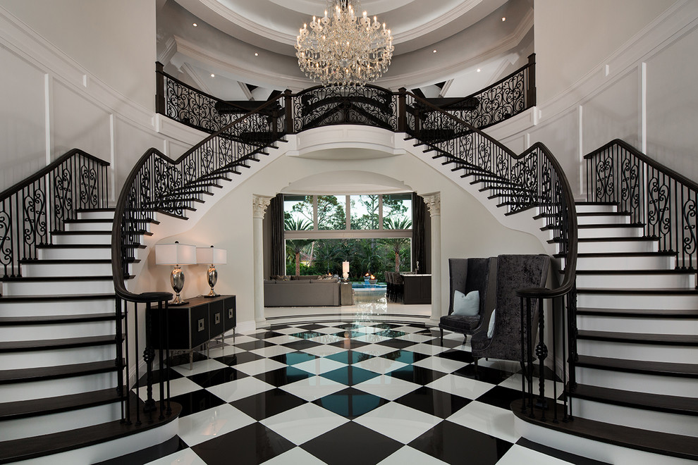 Traditional wood curved staircase in Miami with painted wood risers and metal railing.