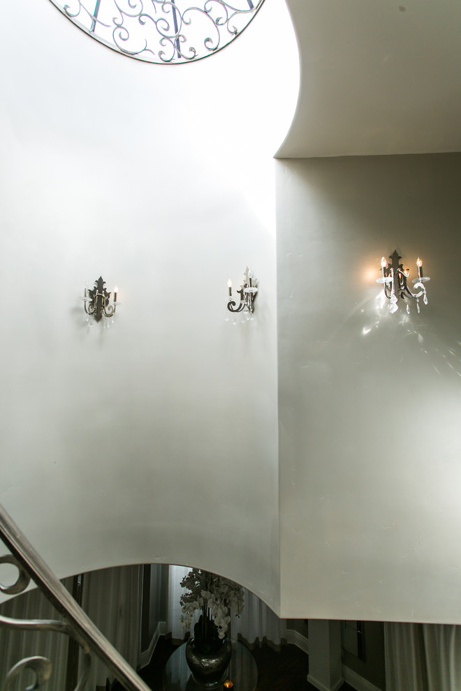Example of a mid-sized transitional medium tone wood floor and brown floor foyer design with white walls