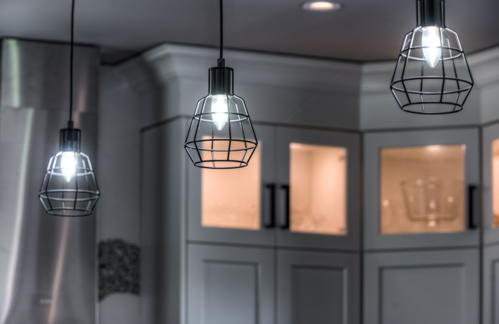 Inspiration for a transitional eat-in kitchen remodel with shaker cabinets, white cabinets, stainless steel appliances and an island