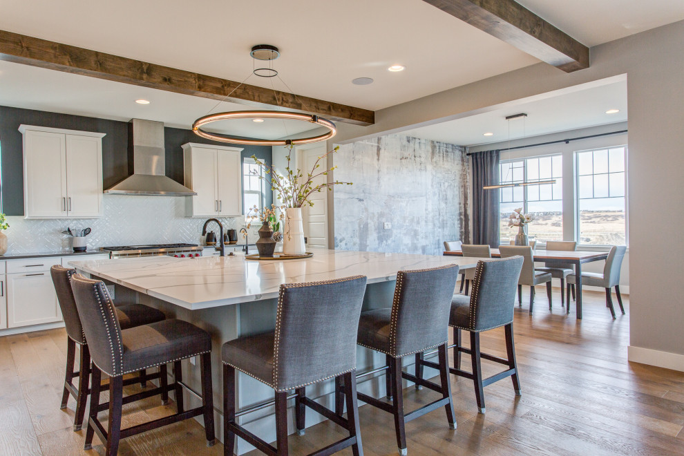Large transitional light wood floor kitchen photo in Denver with shaker cabinets, white cabinets, quartz countertops and an island