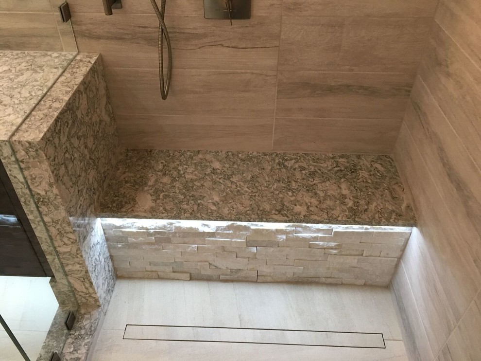 Design ideas for a large contemporary master bathroom in Orlando with flat-panel cabinets, dark wood cabinets, a drop-in tub, a double shower, white tile, porcelain tile, porcelain floors, an undermount sink and engineered quartz benchtops.