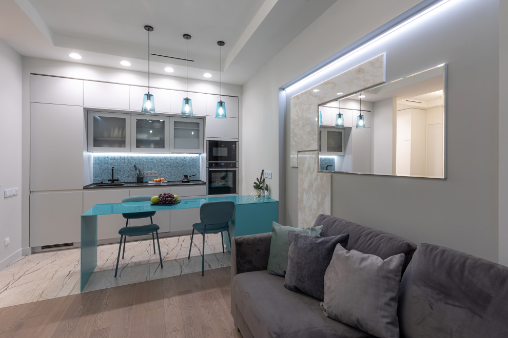 Design ideas for a small contemporary kitchen in Moscow with a single-bowl sink, flat-panel cabinets, grey cabinets, glass worktops, mosaic tiled splashback, black appliances, ceramic flooring, an island, beige floors, turquoise worktops and a coffered ceiling.