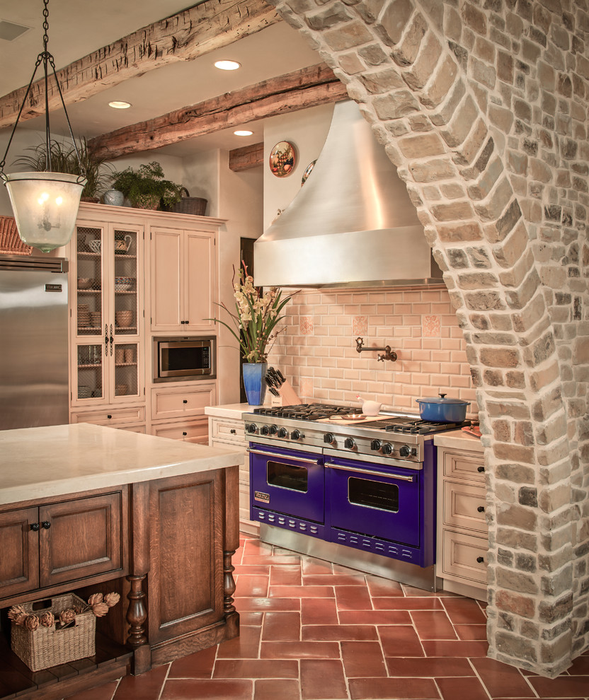 Inspiration for a mediterranean kitchen in Houston with subway tile splashback and coloured appliances.