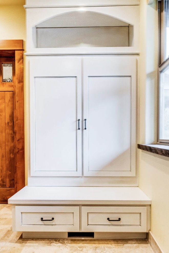 Mid-sized transitional gender-neutral travertine floor mudroom photo in Orange County with open cabinets, light wood cabinets, beige walls and a white front door