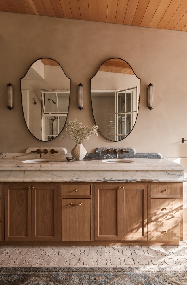 Hill Country Village Legacy Home - Freestanding bathtub - large transitional master beige tile and ceramic tile cement tile floor and double-sink freestanding bathtub idea in Austin with recessed-panel cabinets, beige cabinets, beige walls, an undermount sink, marble countertops, a hinged shower door, white countertops and a built-in vanity