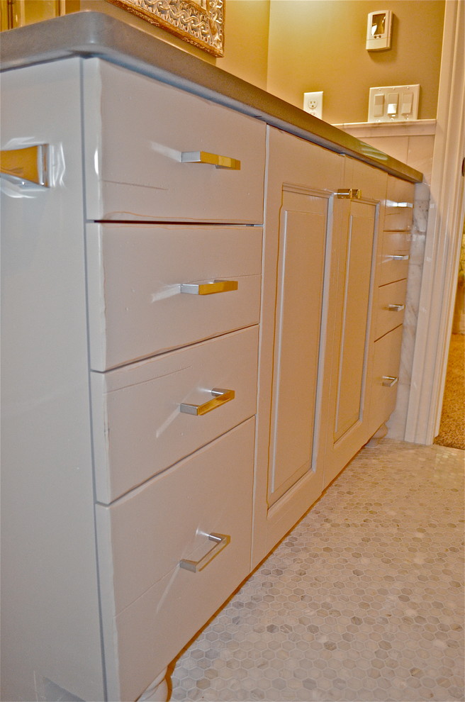 Example of a mountain style white tile marble floor home design design in Omaha with an undermount sink and solid surface countertops