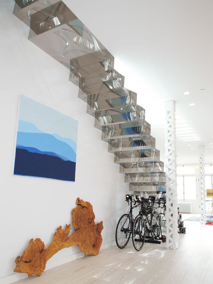This is an example of a mid-sized scandinavian glass straight staircase in New York with glass risers.
