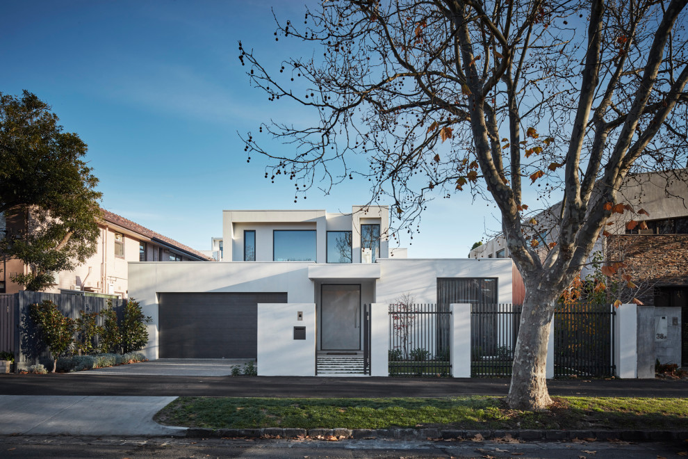 Mid-sized modern two-storey stucco white house exterior in Melbourne with a flat roof.