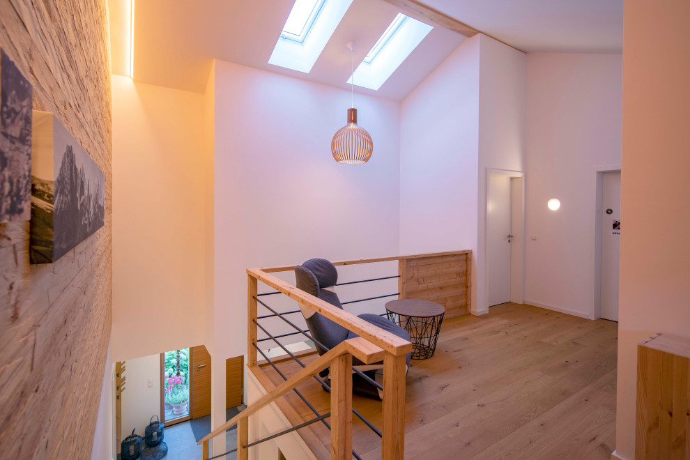 Landhaus Flur mit weißer Wandfarbe, braunem Holzboden und Holzwänden in München