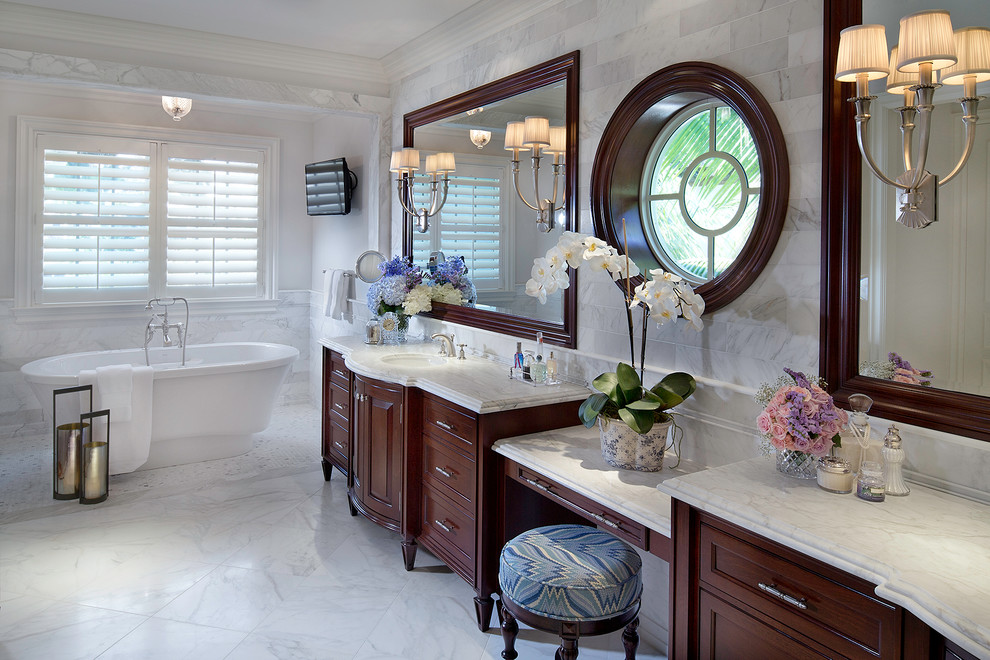 This is an example of a traditional bathroom in Miami with recessed-panel cabinets, dark wood cabinets and a freestanding tub.