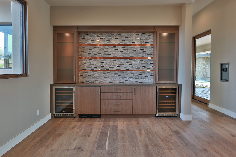 Large contemporary home bar in Phoenix with flat-panel cabinets, brown cabinets, quartz benchtops, multi-coloured splashback, mosaic tile splashback and medium hardwood floors.