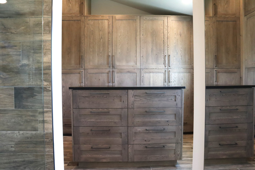 This is an example of a country dressing room in Salt Lake City with shaker cabinets, medium wood cabinets, medium hardwood floors and brown floor.