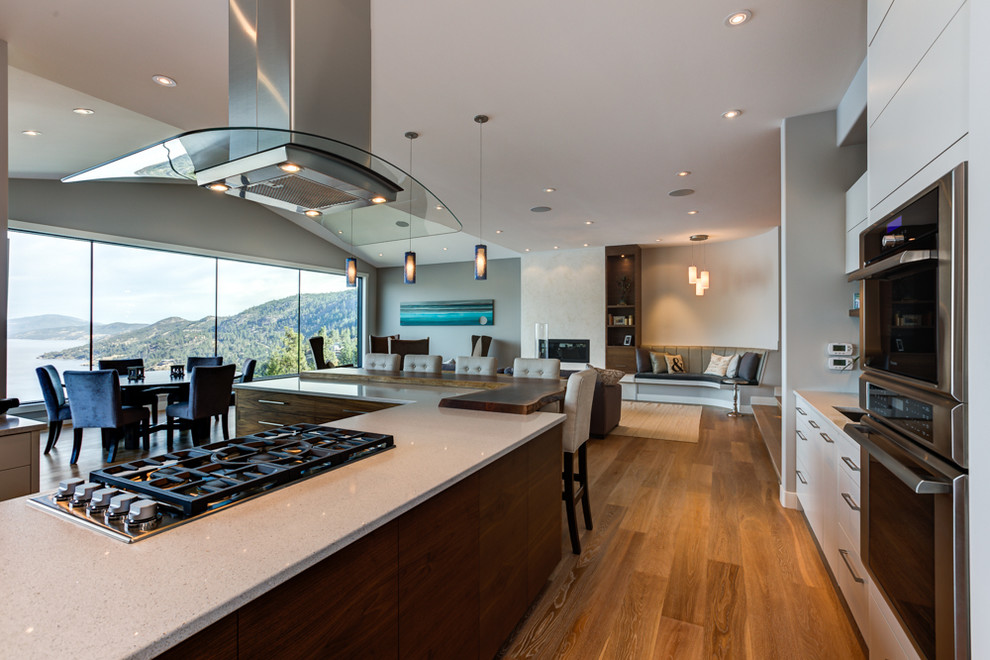 This is an example of a contemporary kitchen in Vancouver with dark wood cabinets, granite benchtops, blue splashback and with island.