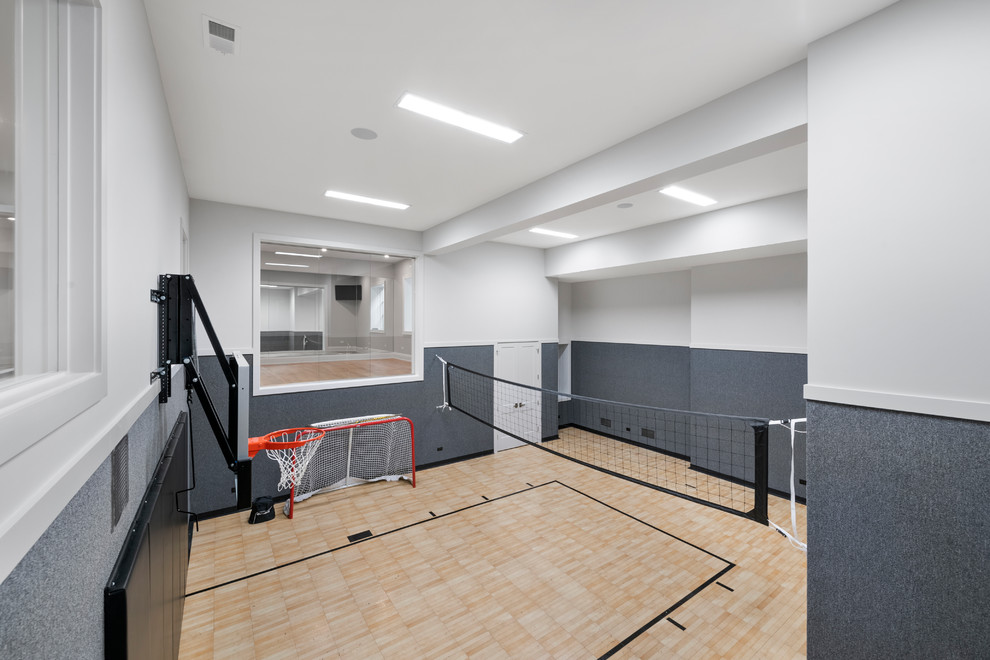 Design ideas for an expansive transitional indoor sport court in Chicago with white walls, vinyl floors and brown floor.