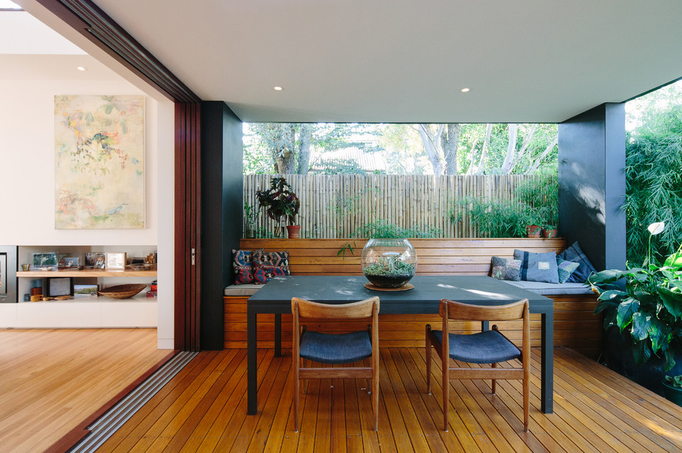 Design ideas for a mid-sized contemporary backyard deck in Sydney with a roof extension.