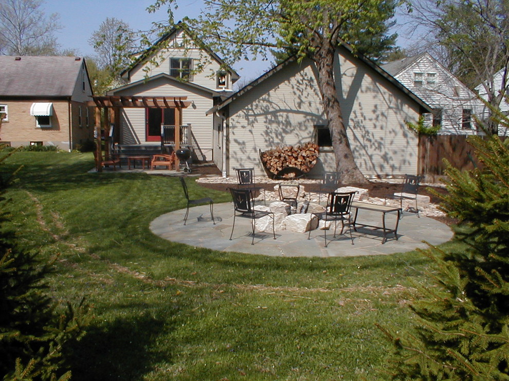 Inspiration for a traditional backyard patio in Cincinnati with a fire feature, natural stone pavers and a pergola.