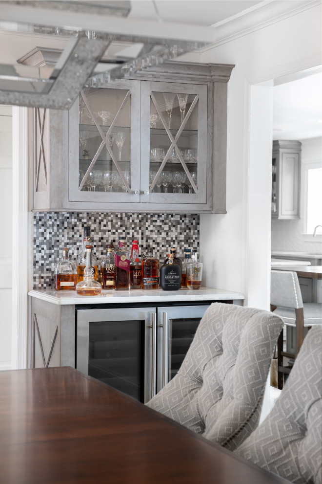 Design ideas for a small contemporary single-wall dry bar in Newark with glass-front cabinets, grey cabinets, engineered stone countertops, black splashback, mosaic tiled splashback, dark hardwood flooring, brown floors and white worktops.