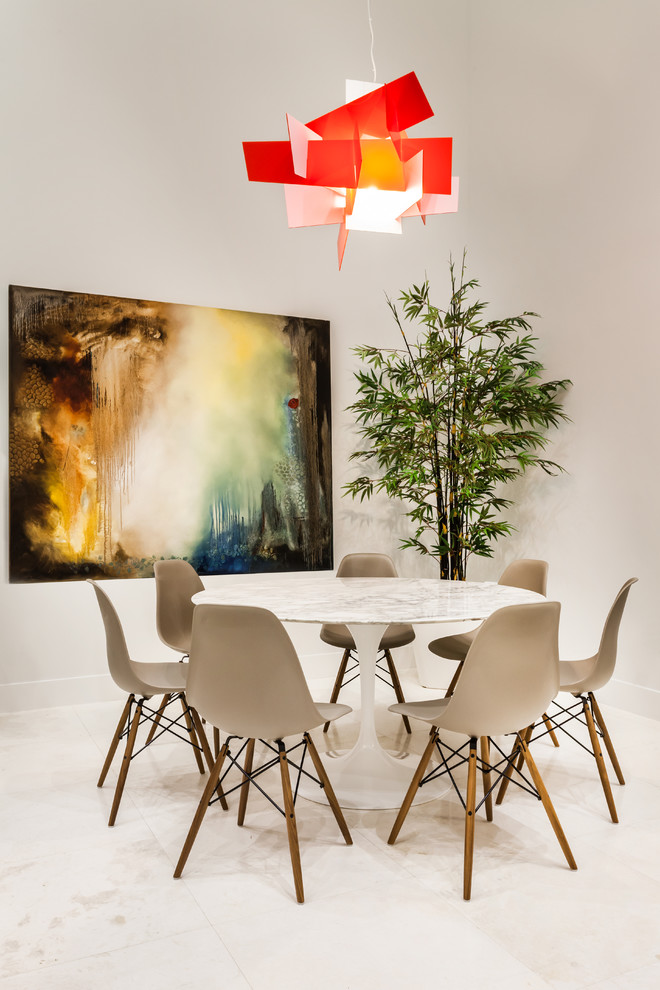 This is an example of a contemporary dining room in Miami with white walls.