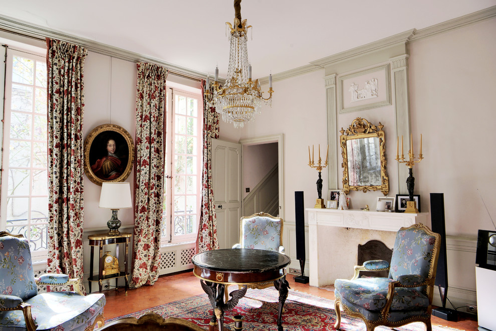 Large traditional formal enclosed living room in Marseille with pink walls, porcelain floors, a standard fireplace, a plaster fireplace surround and white floor.