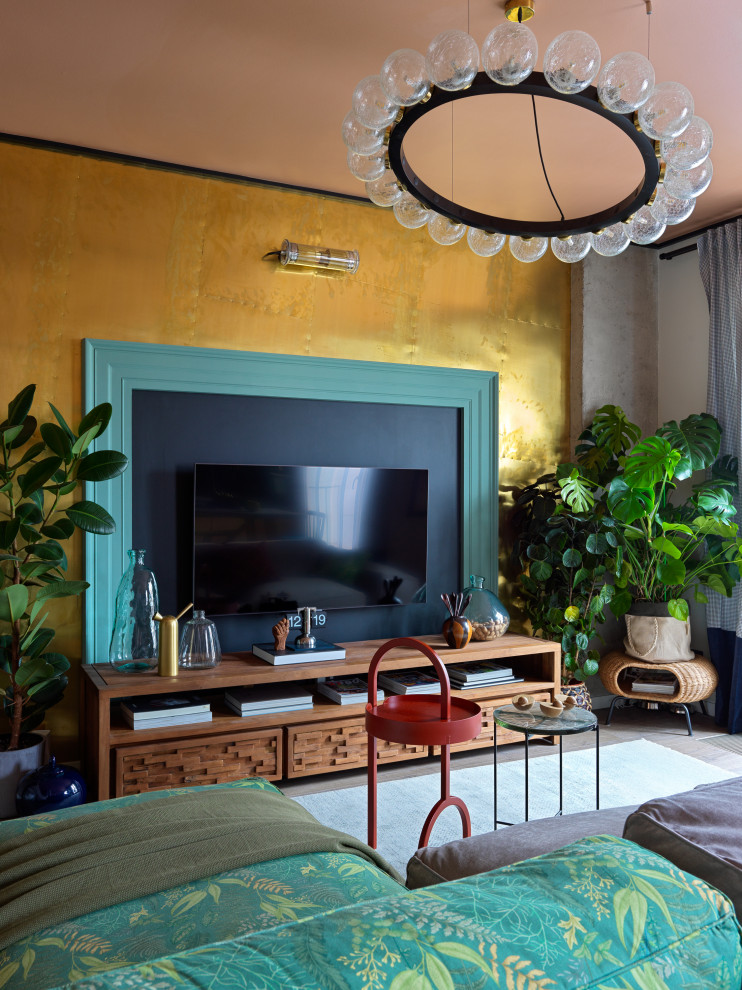 Ejemplo de salón para visitas bohemio de tamaño medio con paredes multicolor, suelo laminado, televisor colgado en la pared y suelo marrón