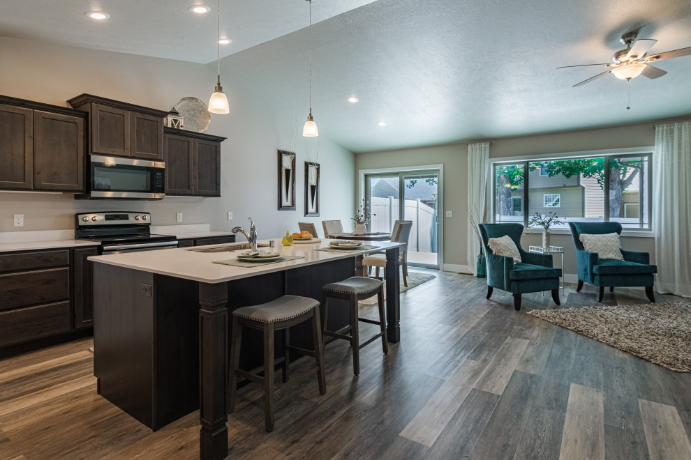Inspiration for a mid-sized transitional l-shaped vinyl floor and gray floor eat-in kitchen remodel with an undermount sink, shaker cabinets, dark wood cabinets, quartz countertops, quartz backsplash, stainless steel appliances, an island and white countertops