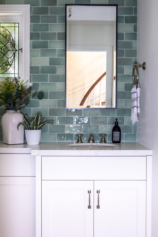Inspiration for a small classic cloakroom in Los Angeles with shaker cabinets, white cabinets, a one-piece toilet, green tiles, ceramic tiles, white walls, medium hardwood flooring, a submerged sink, engineered stone worktops, grey floors, white worktops and a built in vanity unit.