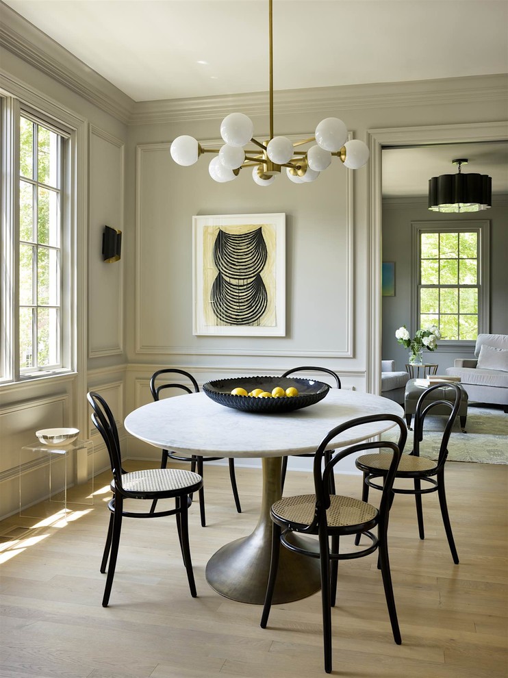 Transitional dining room in DC Metro with grey walls, light hardwood floors and beige floor.