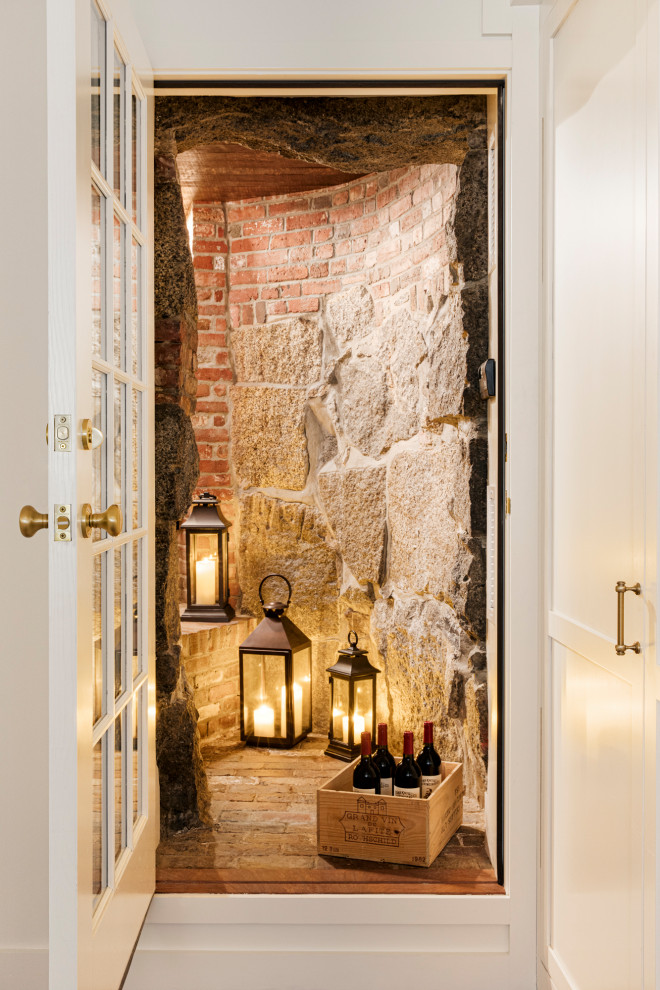Example of a small eclectic brick floor wine cellar design in Boston with storage racks