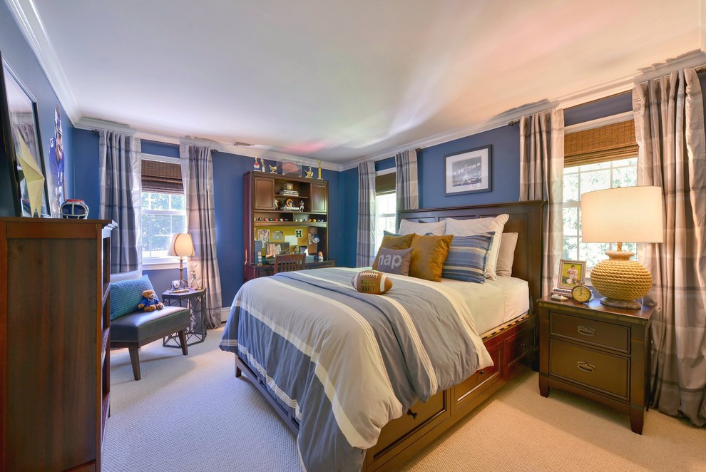 This is an example of a mid-sized transitional kids' room for boys in New York with blue walls and carpet.