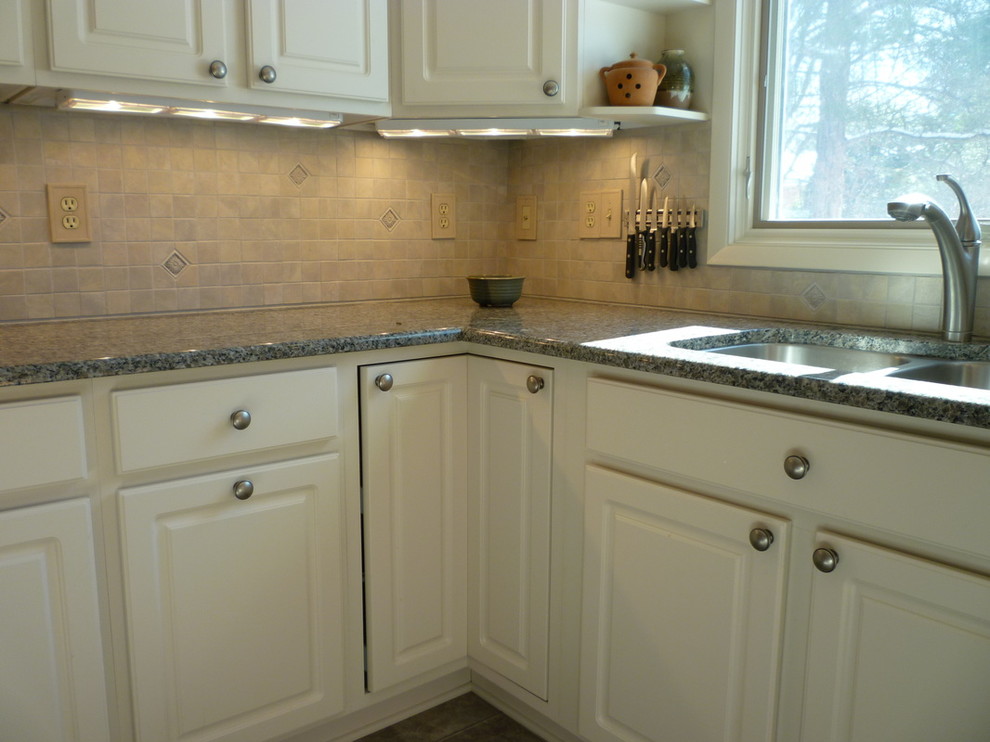 Inspiration for a mid-sized l-shaped kitchen remodel in Richmond with a double-bowl sink, white cabinets, granite countertops and ceramic backsplash