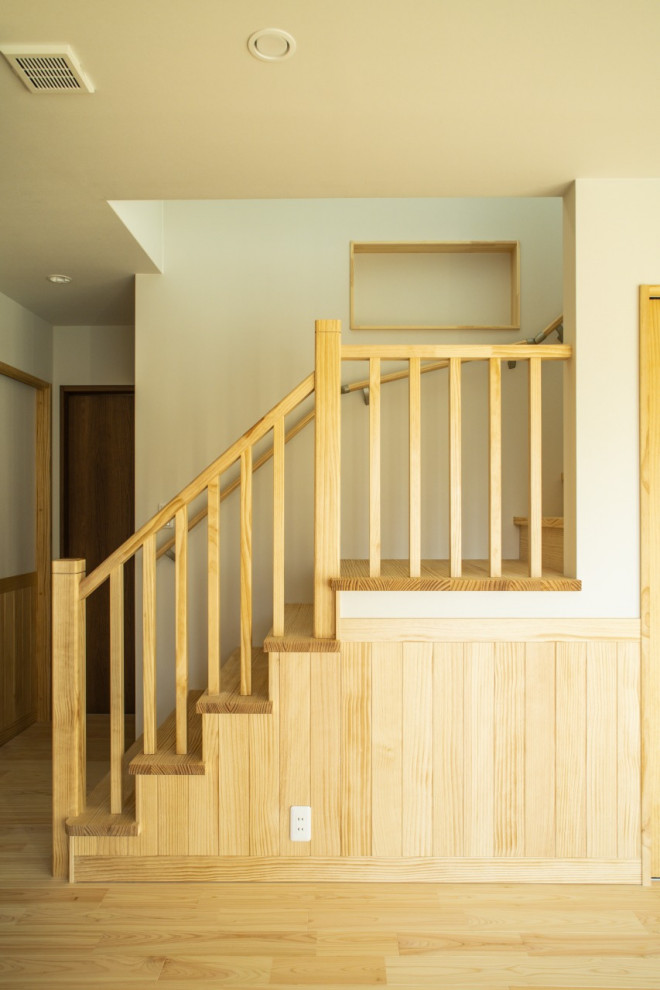 Photo of a mid-sized asian staircase in Other with wallpaper.