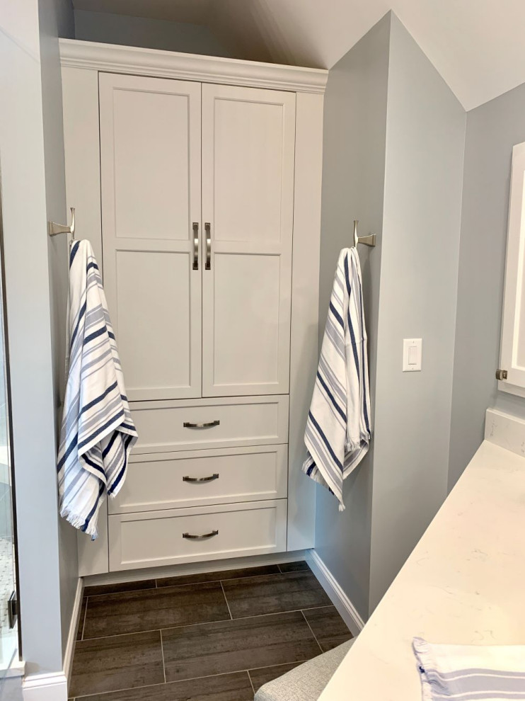 Inspiration for a mid-sized transitional master bathroom in Charlotte with shaker cabinets, white cabinets, a double shower, gray tile, porcelain tile, grey walls, porcelain floors, an undermount sink, quartzite benchtops, grey floor, a hinged shower door, white benchtops, a niche, a single vanity, a built-in vanity and vaulted.