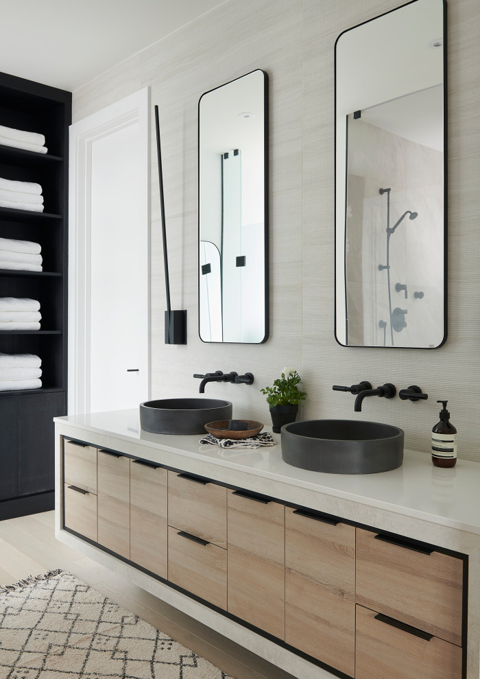 This is an example of a mid-sized contemporary master bathroom in Toronto with flat-panel cabinets, light wood cabinets, a japanese tub, a corner shower, a bidet, beige tile, porcelain tile, white walls, light hardwood floors, a vessel sink, engineered quartz benchtops, beige floor, a hinged shower door, beige benchtops, an enclosed toilet, a double vanity and a floating vanity.