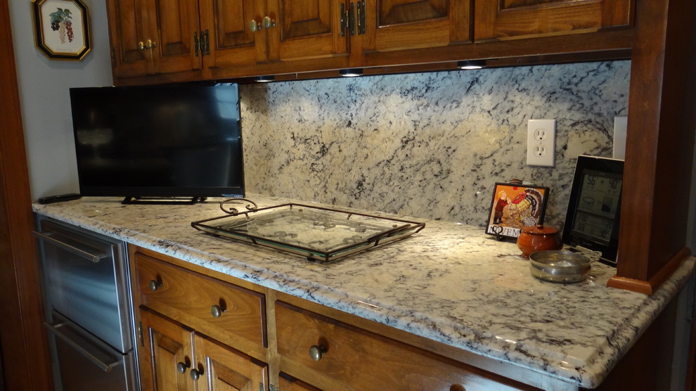 White eyes granite with full height granite backsplash Traditional