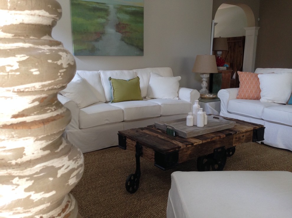 Large beach style open concept living room in Charleston with beige walls and light hardwood floors.