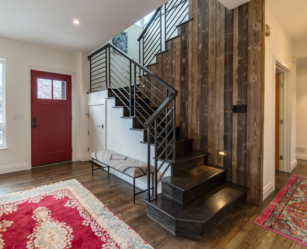 This is an example of a mid-sized contemporary wood u-shaped staircase in Denver with wood risers and metal railing.