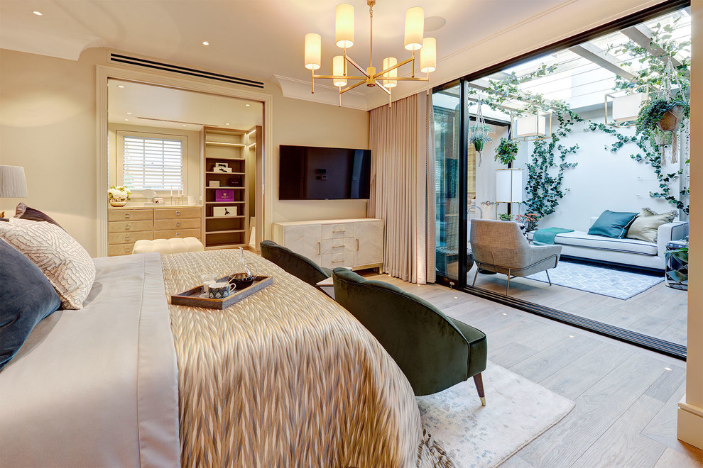 Inspiration for a large contemporary master bedroom in London with beige walls, medium hardwood floors and brown floor.