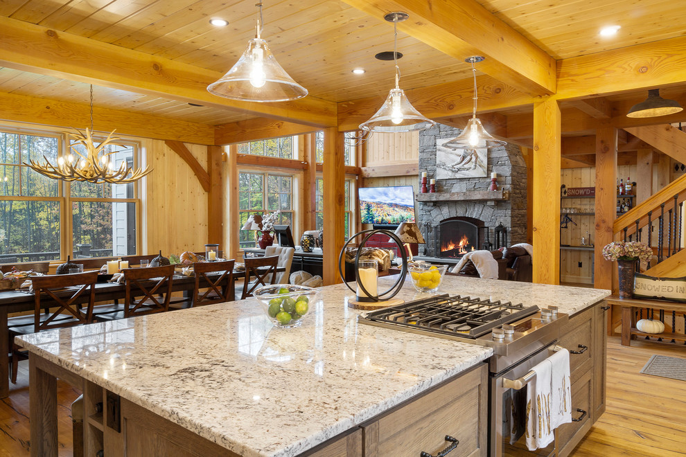 Inspiration for a large country l-shaped open plan kitchen in Boston with a farmhouse sink, shaker cabinets, white cabinets, granite benchtops, white splashback, stainless steel appliances, medium hardwood floors and with island.