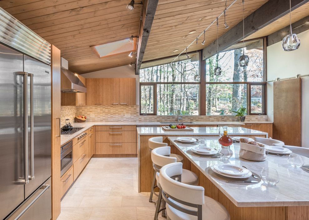 Large contemporary l-shaped open plan kitchen in Boston with an undermount sink, flat-panel cabinets, light wood cabinets, granite benchtops, beige splashback, brick splashback, stainless steel appliances, ceramic floors, with island and white floor.