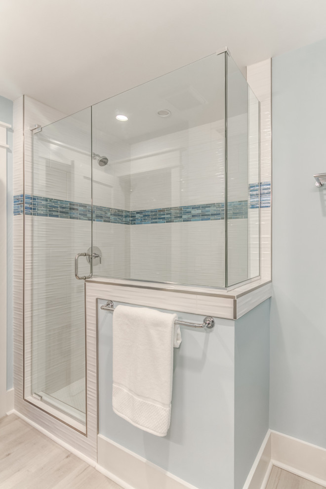 Inspiration for a mid-sized beach style 3/4 bathroom in Wilmington with raised-panel cabinets, grey cabinets, cement tile, blue walls, an undermount sink, marble benchtops, grey floor, a hinged shower door, grey benchtops, a niche, a single vanity and a freestanding vanity.
