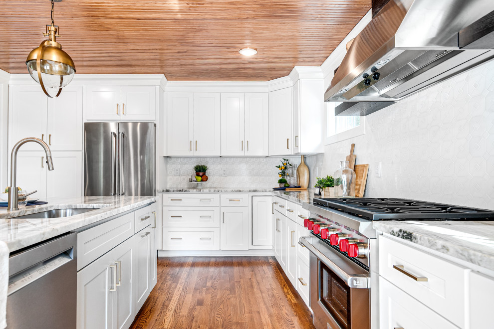 Design ideas for a large traditional kitchen/diner in Richmond with a single-bowl sink, shaker cabinets, white cabinets, marble worktops, white splashback, medium hardwood flooring, an island, brown floors and a wood ceiling.