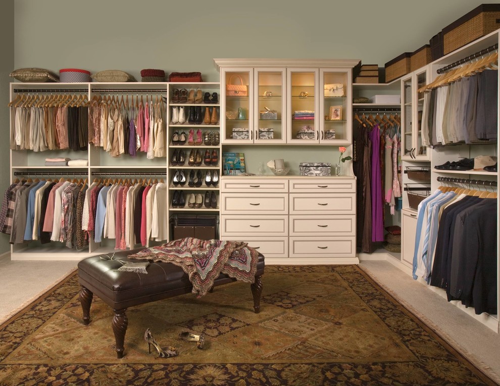 Photo of a large traditional gender-neutral walk-in wardrobe in Other with recessed-panel cabinets, beige cabinets, carpet and beige floor.