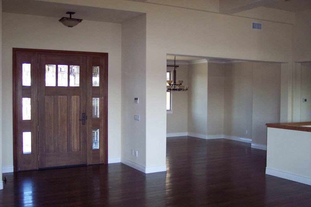 Inspiration for a mid-sized contemporary front door in San Luis Obispo with beige walls, dark hardwood floors, a single front door and a medium wood front door.