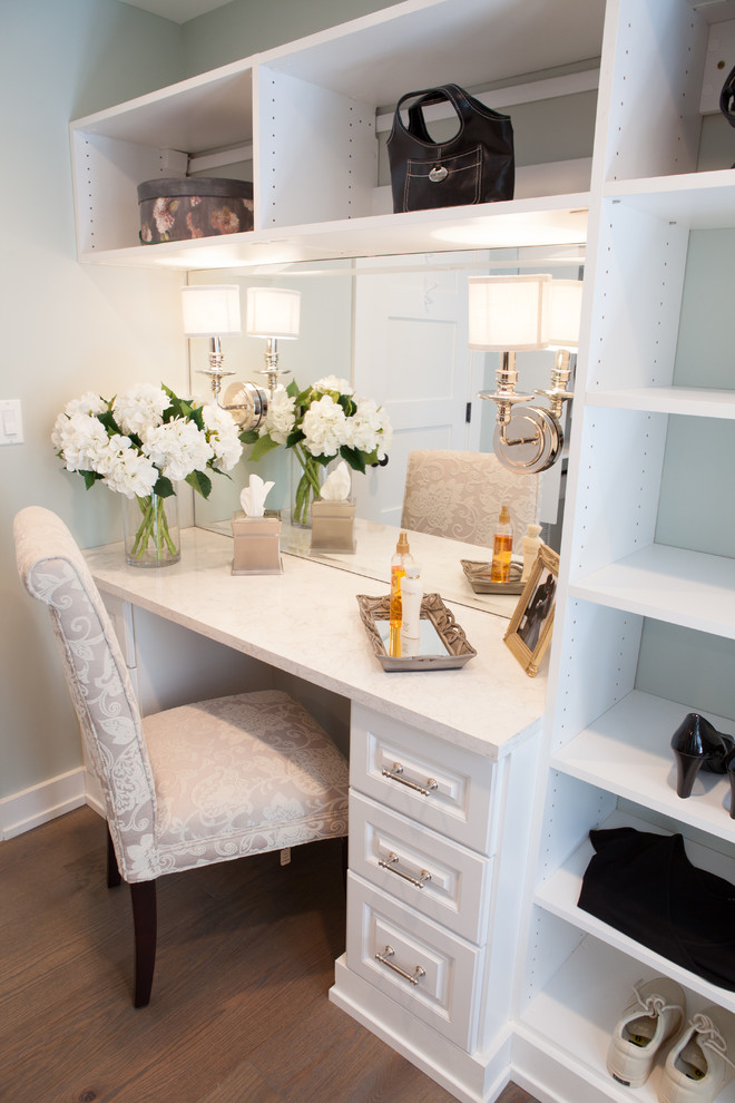 Large country gender-neutral dressing room in Chicago with white cabinets, medium hardwood floors and raised-panel cabinets.