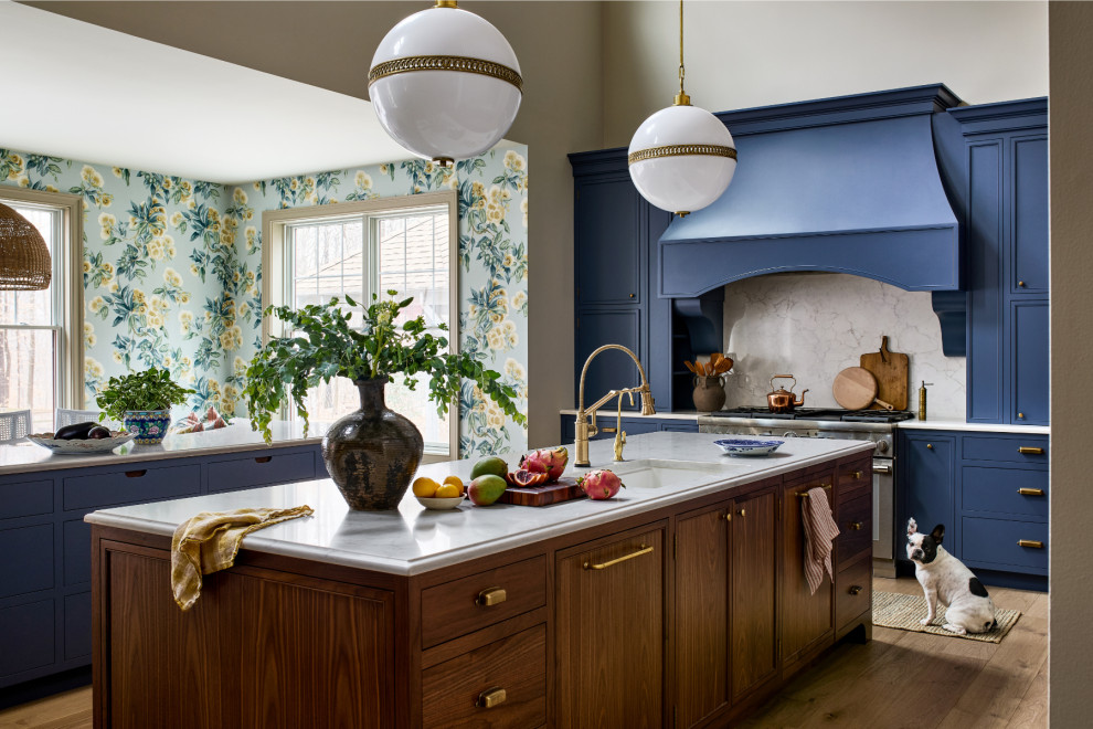 Example of a large transitional galley light wood floor, brown floor and vaulted ceiling open concept kitchen design in Baltimore with a drop-in sink, medium tone wood cabinets, gray backsplash, two islands, white countertops, stainless steel appliances, quartzite countertops and marble backsplash
